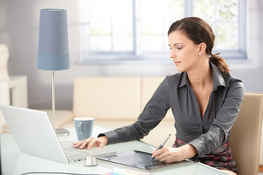 Working woman using laptop and tablet