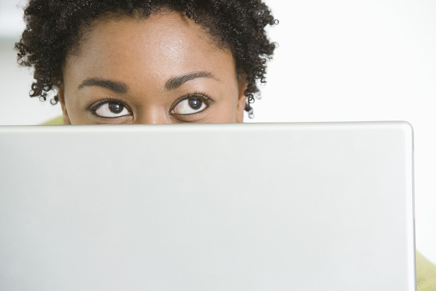 Woman looking over computer monitor