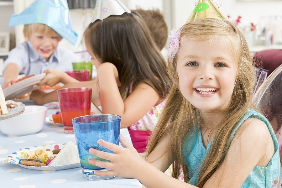 Smiling girl at birthday party table