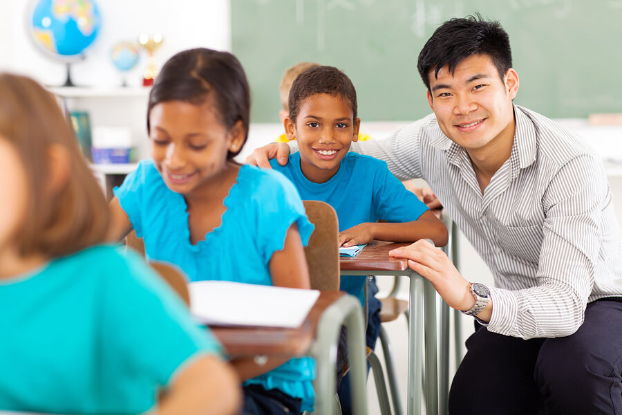 boy writing in classroom