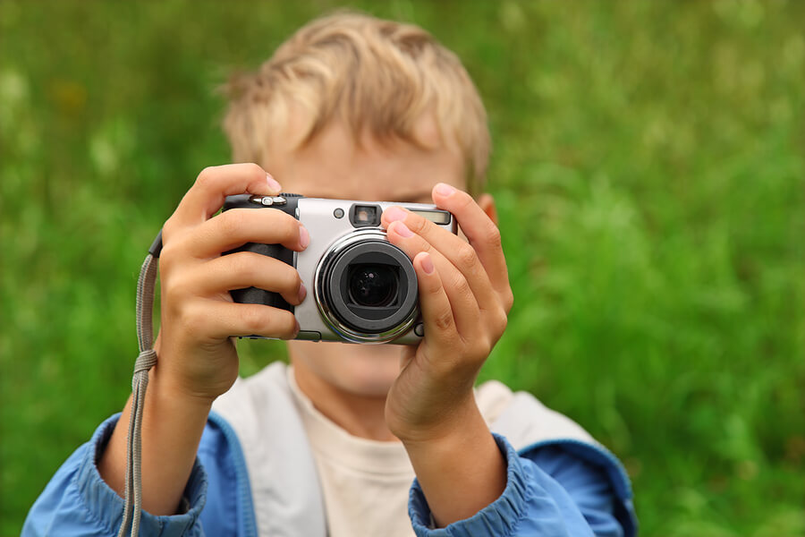 Summer camp essentials, boy with camera