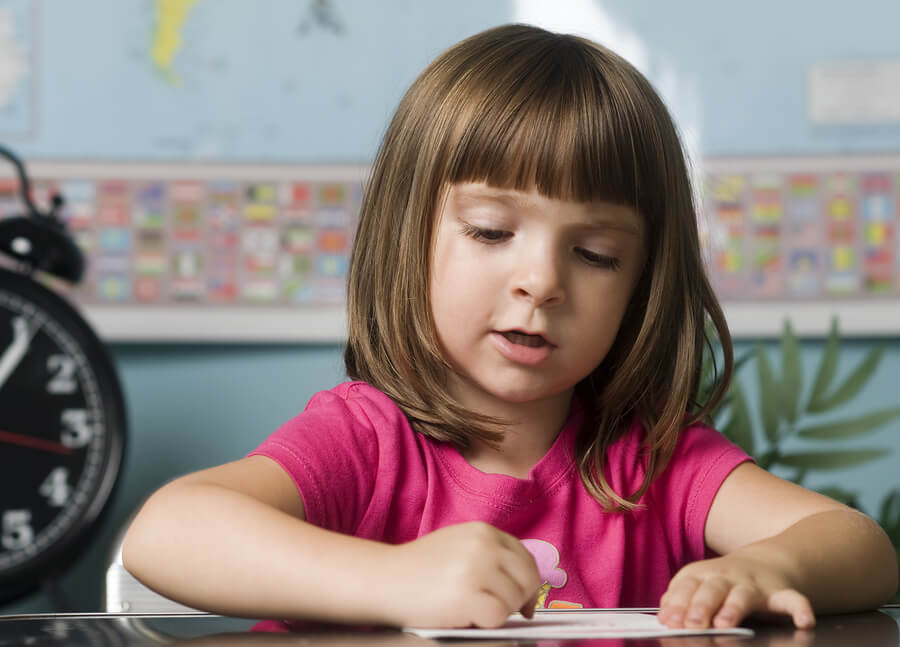 child learning to read, write letters