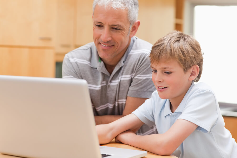 Homework help, father and son using computer