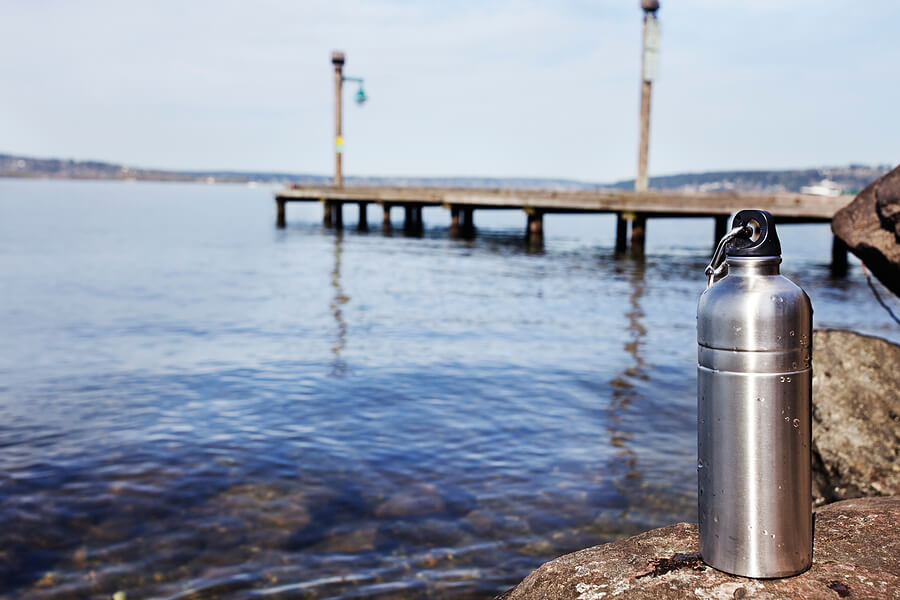 Summer camp essentials, reusable water bottle near beach
