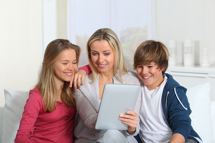 mother and teens using tablet