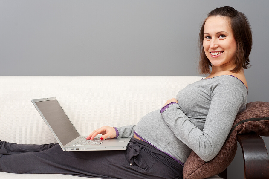 pregnancy decisions, woman with laptop looking up baby names