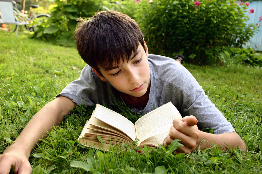 shy teen boy reading