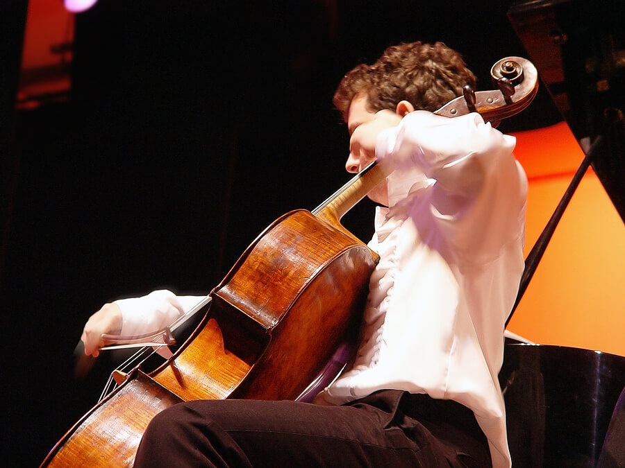 what colleges look for, boy playing cello instrument