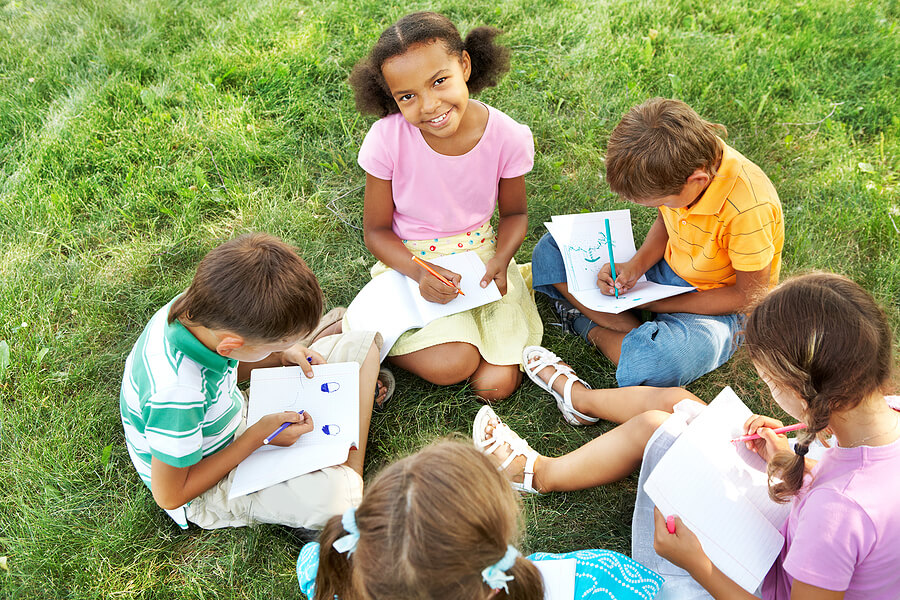 Summer camp essentials, camp kids writing letters or journaling on paper