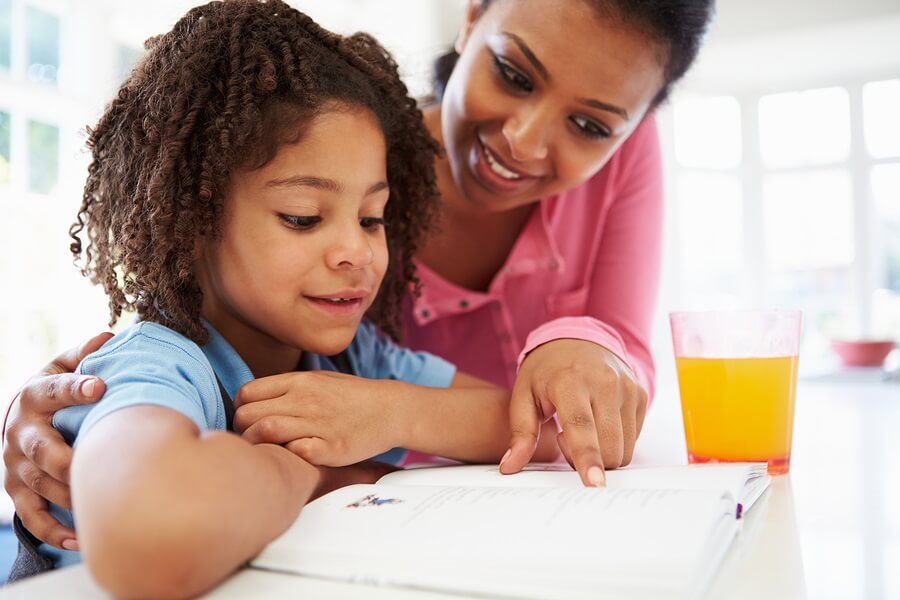 Mother and Daughter in Kitchen Doing Homework