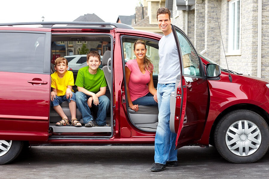 Tips for Road Trips and Car Travel with Kids, family of four ready for road trip in minivan