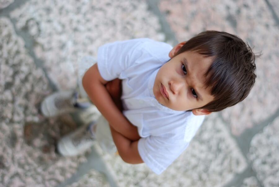 Angry boy with crossed arms