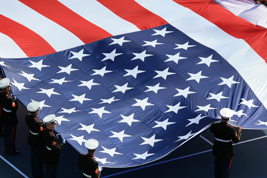 Supporting Our Troops, troops in uniform holding giant US flag