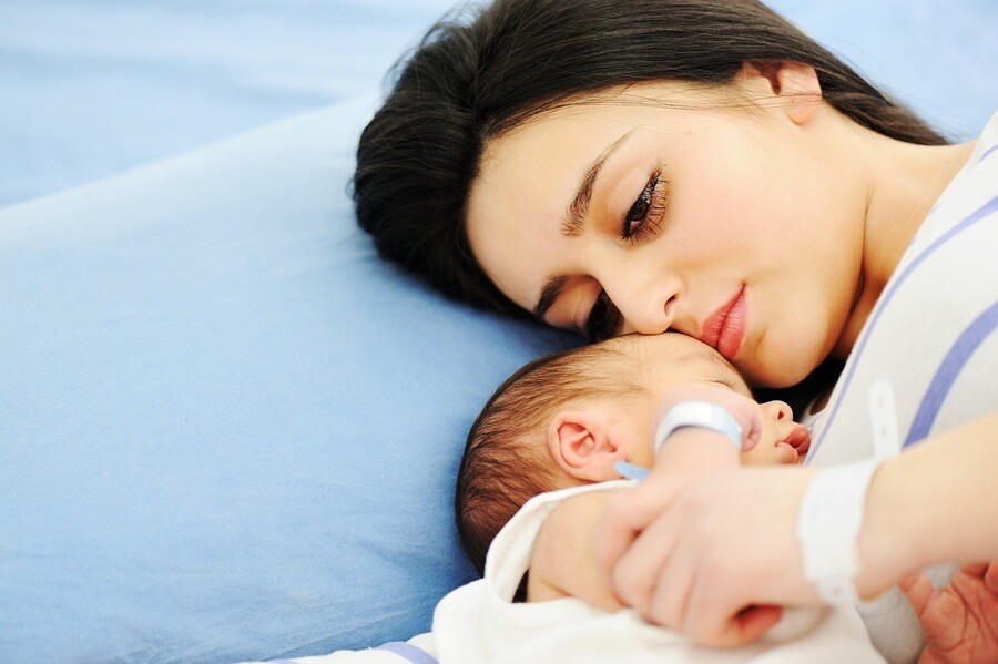 Woman laying with newborn baby