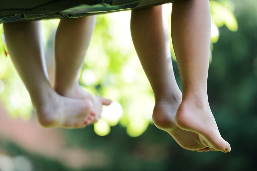 Children's feet dangling from hammock