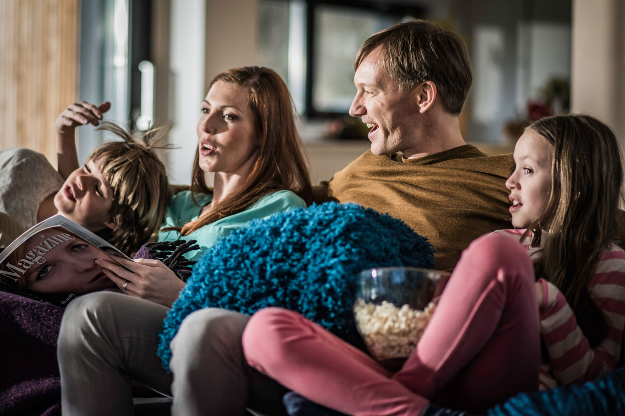 family watching tv on couch