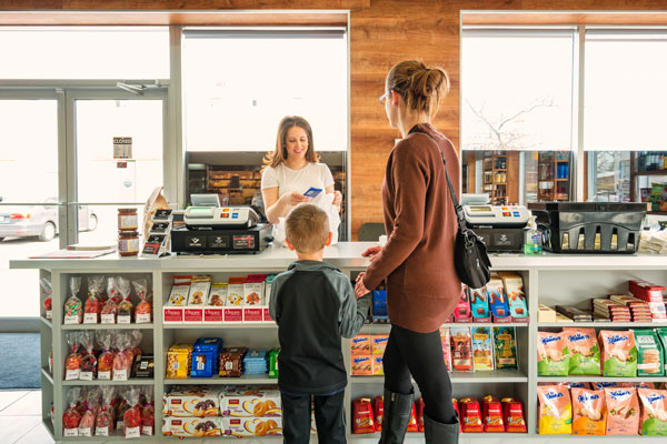 mother and son engaging with cashier