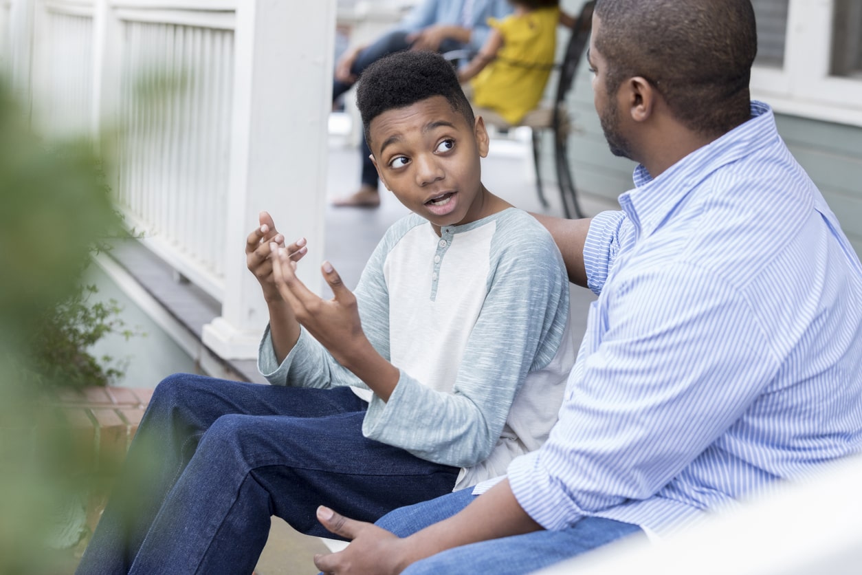 Father and preteen son discuss the safety of AI technology in the house.
