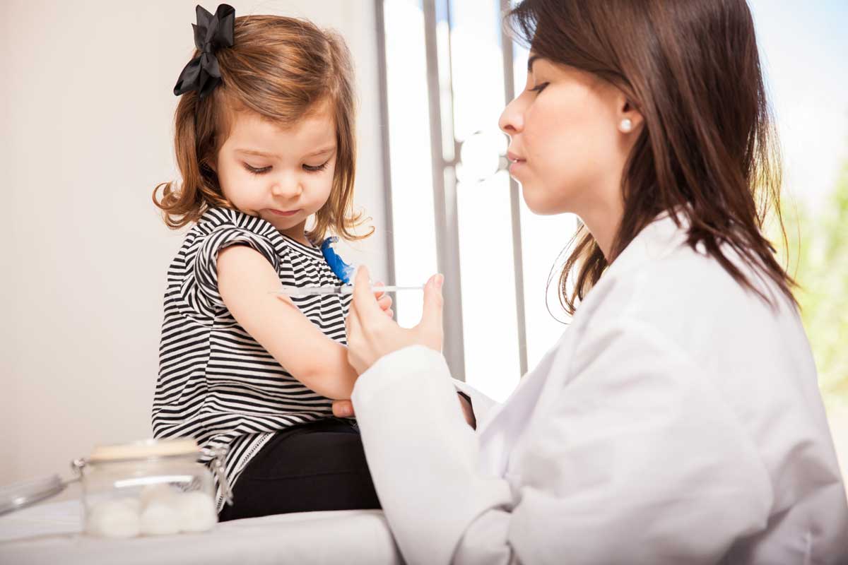 little girl getting vaccine shot