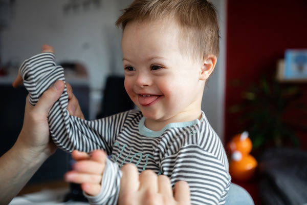 Toddler boy with Down Syndrome Playing With Dad