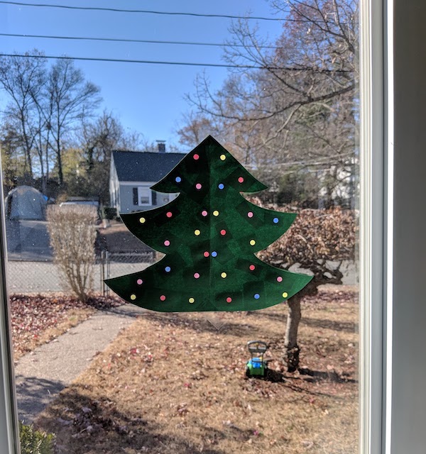Completed Paper Christmas Tree Craft Put Up Against A Large Bright Window 