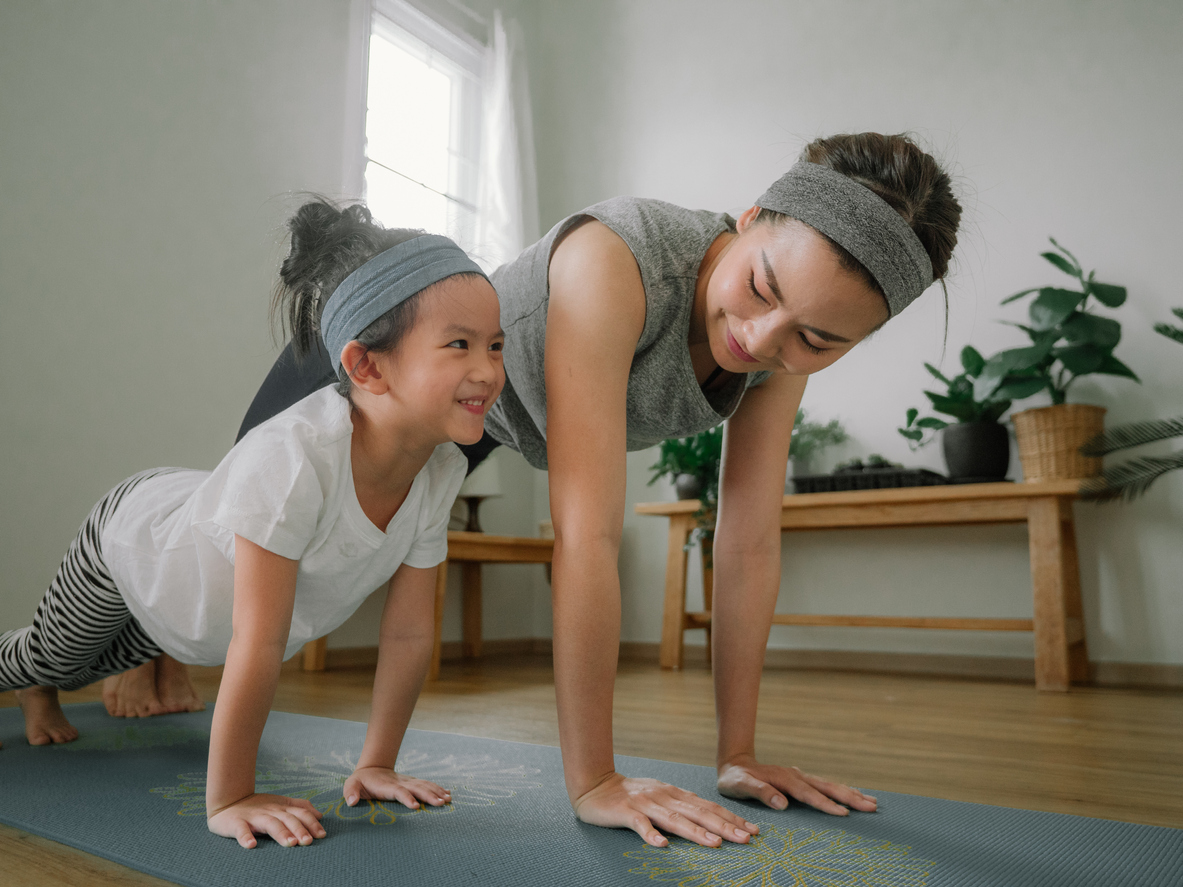 Sport young asian woman work out with little girl at home