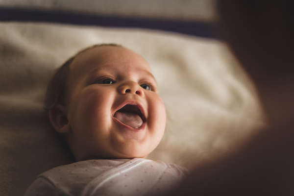 Gender neutral-named baby smiling