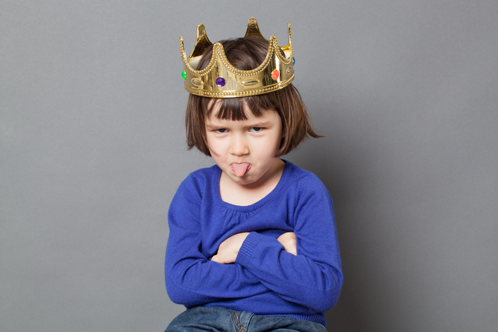 girl in royal crown makes funny face
