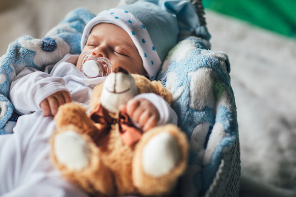 Sleeping baby boy with inspirational name wrapped up in blankets