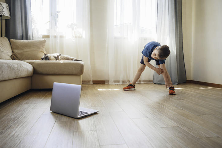kid stretching in an online exercise class 
