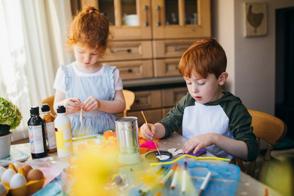 Boy and girl child painting at Friendsgiving table