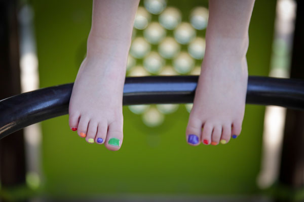 Boy with his toes painted several colors