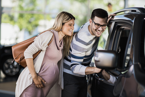Pregnant couple upgrading car for pre-baby bucket list