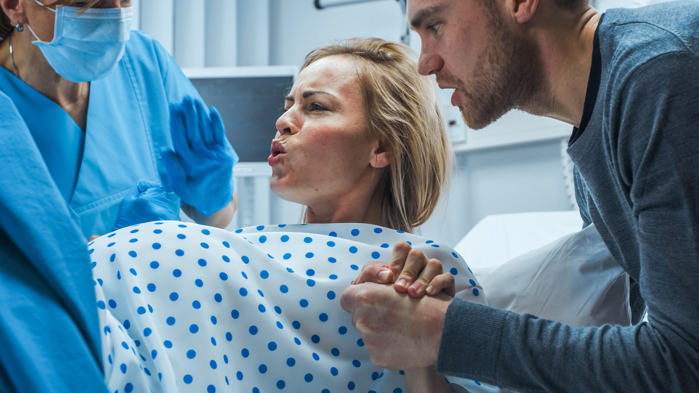 Woman going into labor with husband and doctor next to her