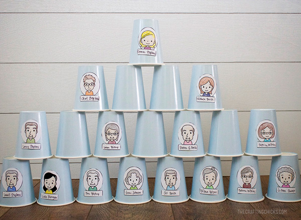Drawings of various family members and their titles taped to stacked paper cups