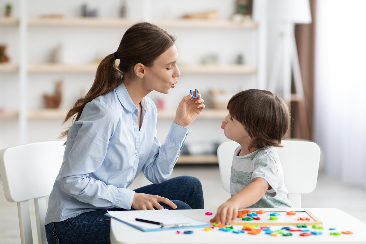 speech therapist teaches young child phonemics