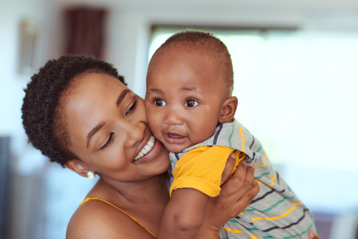 african baby boy held by his mom 