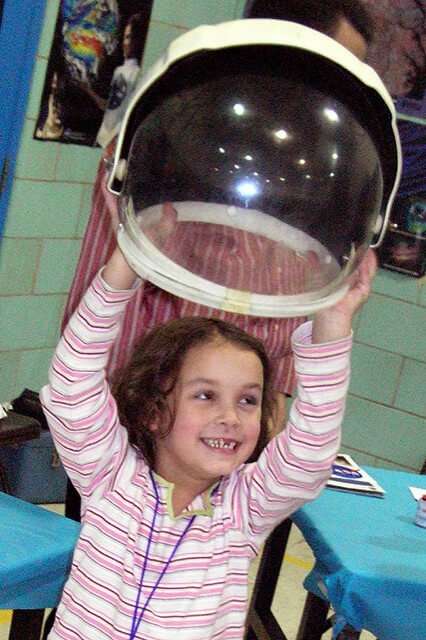 Young Girl Holding Astronaut Helmet