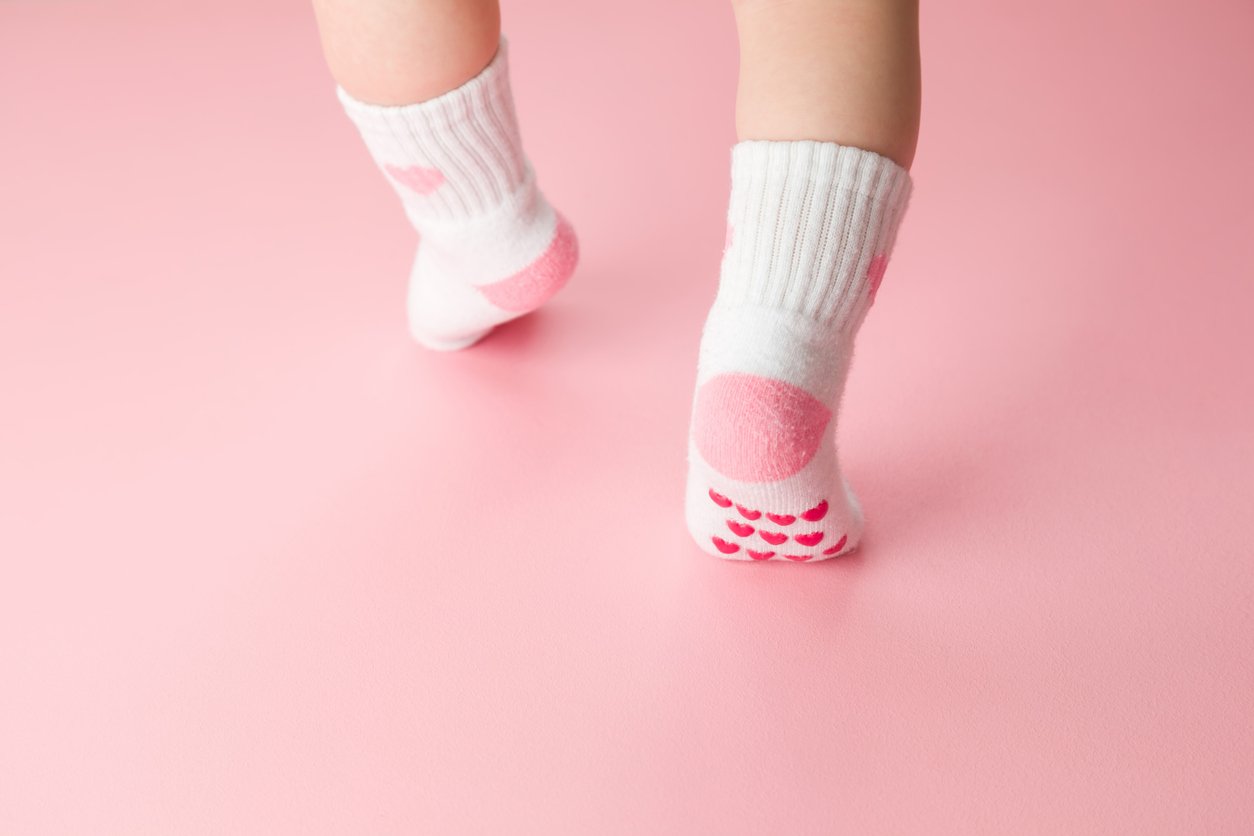 baby girl toe walking in socks