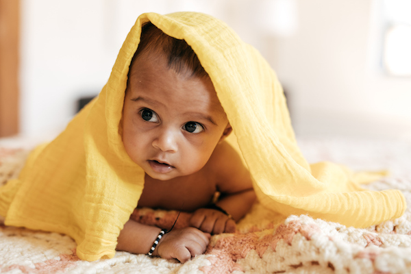 International named baby wrapped in yellow blanket