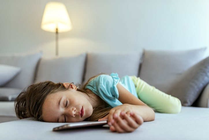 Young girl takes a nap on the sofa