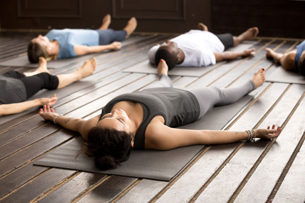 group of people doing yoga focusing on breath