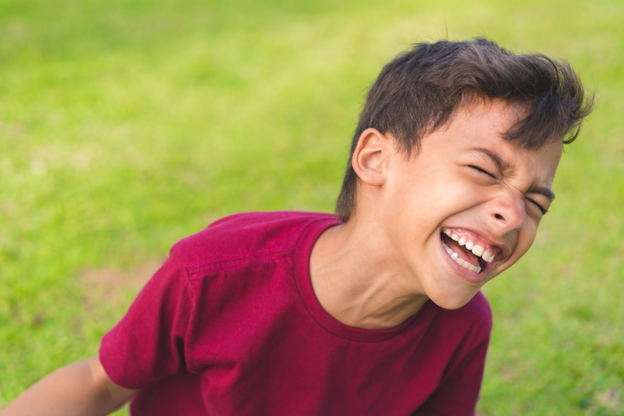 Young Brazilian boy plays outdoors and laughs; Brazilian boy name inspiration