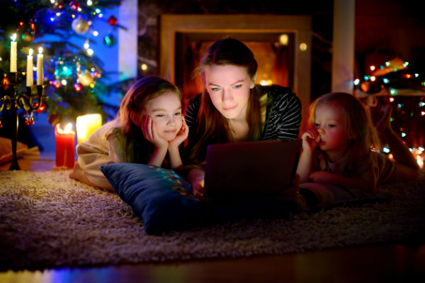 mom and daughters watching Christmas movies