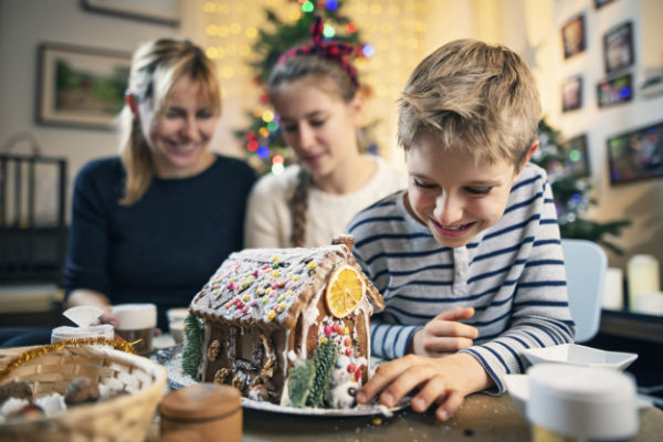 family making gingerbread house