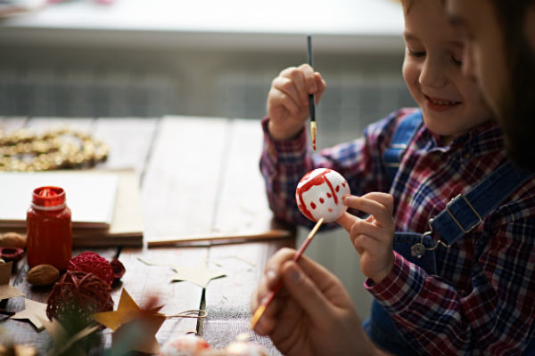 child making homemade ornament craft
