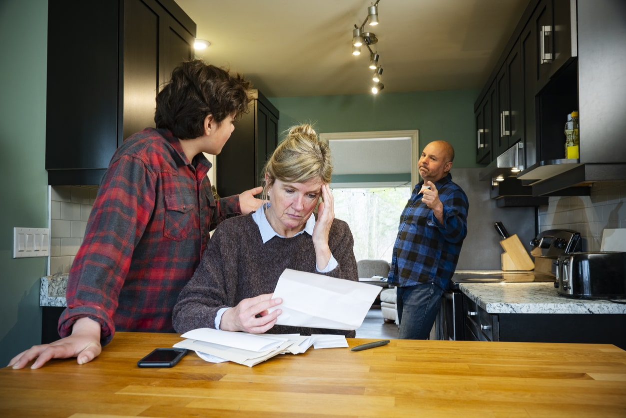 Mother and father stress about son's college applications in the kitchen