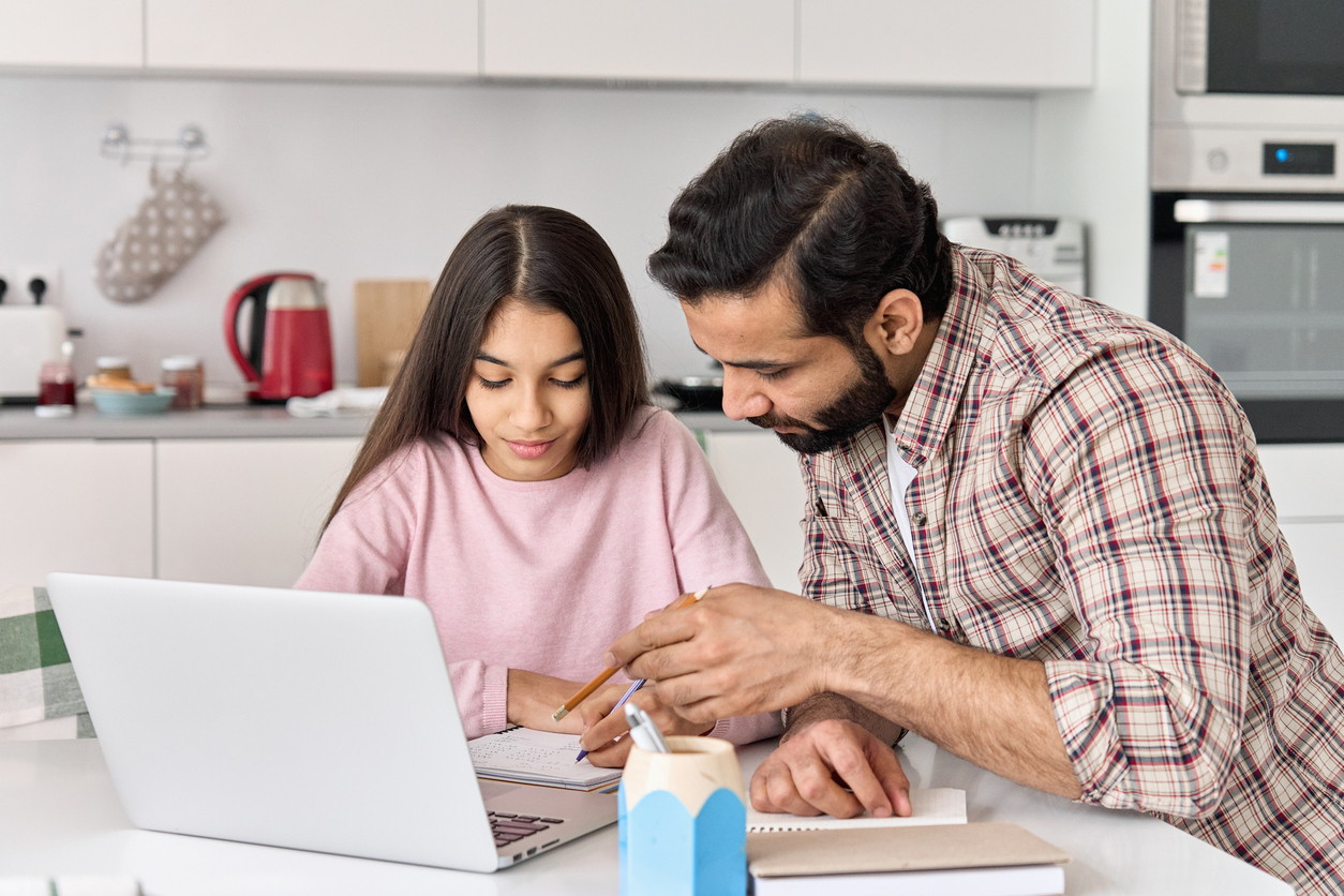 dad helps daughter with homework