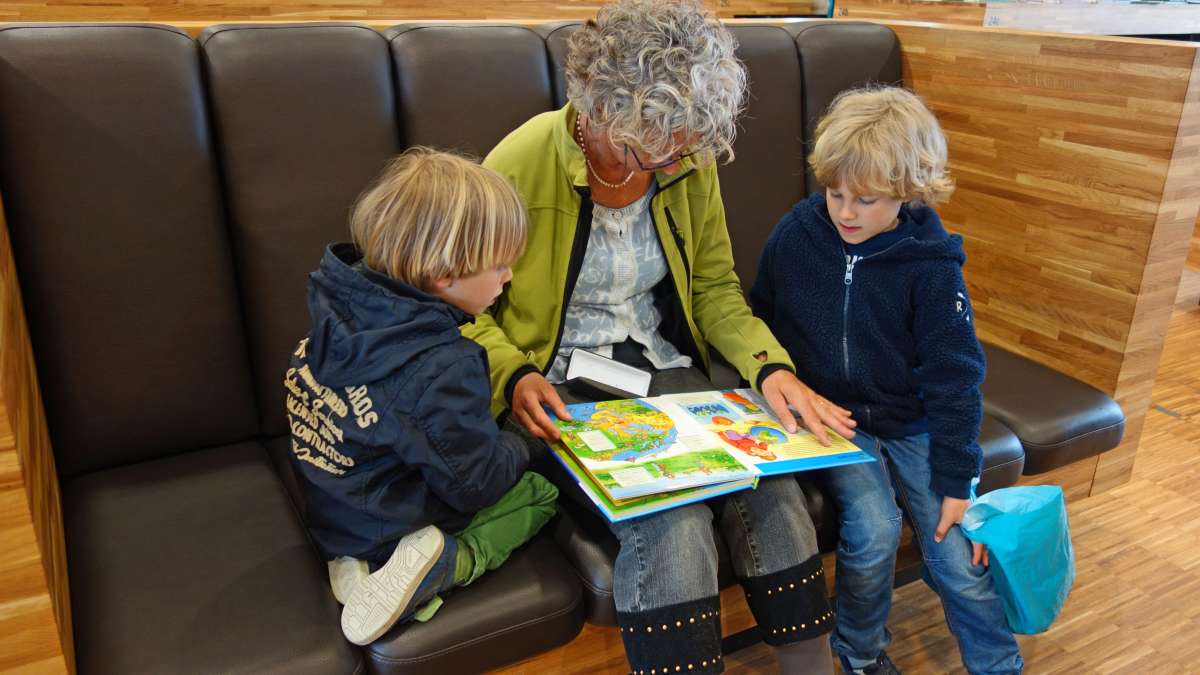 Children reading with grandmother for Get Caught Reading Month