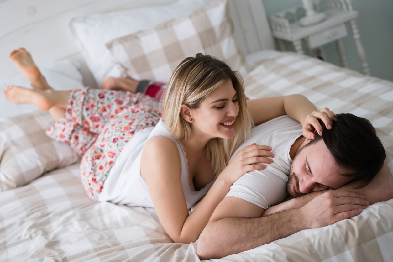 Portrait of young loving couple in bedroom stock photo